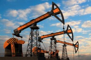 three-orange-oil-pumps-against-cloudy-sky-16955370_Large.jpg